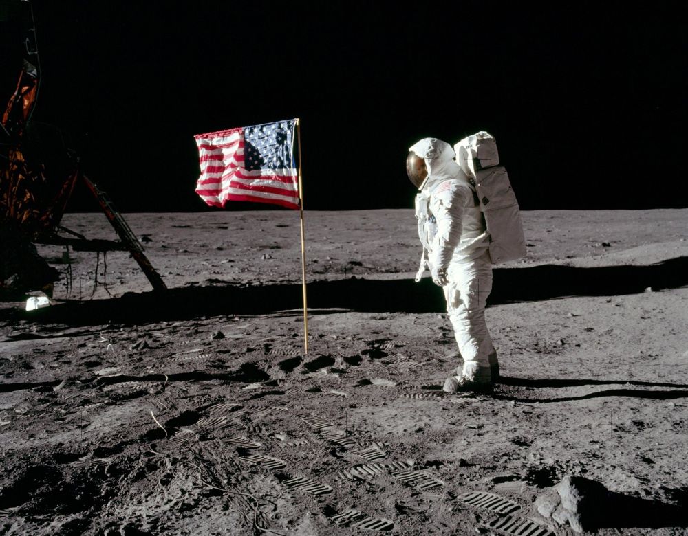 Neil Armstrong on the Moon next to the U.S. flag 