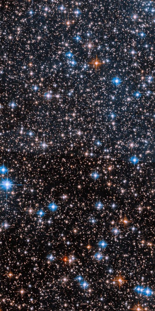 Many stars fill the field of view, ranging in shades of white, red, yellow, and blue.