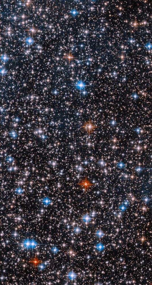 Many stars fill the field of view, ranging in shades of white, red, yellow, and blue.