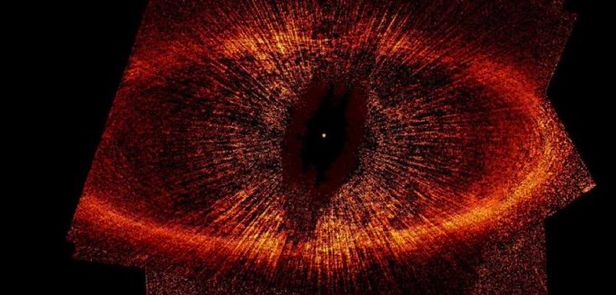A small white dot with a large orange debris disk around it, resembling an eye.