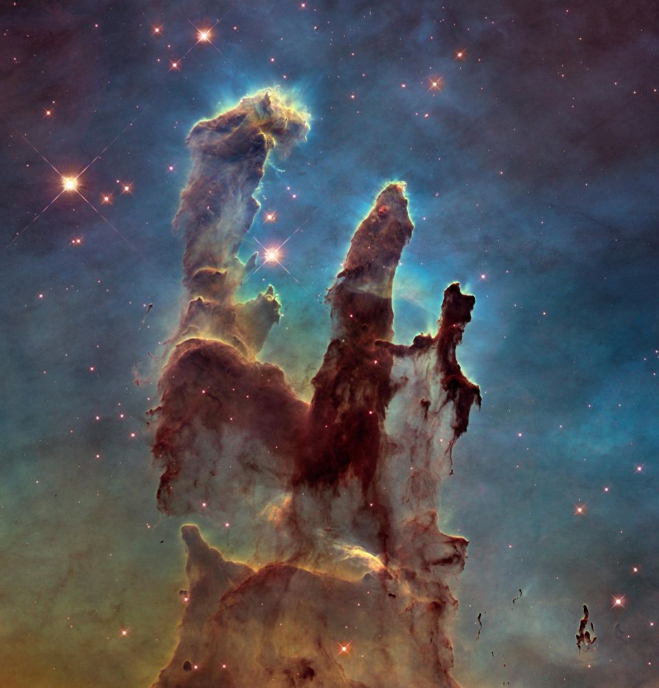 Dark brown pillars rise from the bottom to the top of the image, ending in three points. The background is opaque, set off in yellow and green toward the bottom and blue and purple at the top. A handful of stars of various sizes appear.
