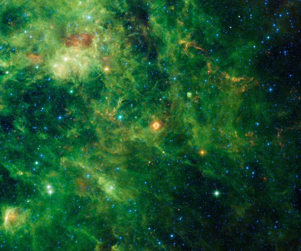 Bright green clouds and dust with blue stars visible