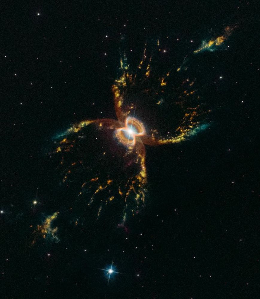 It appears to have two nested hourglass-shaped structures that were sculpted by a whirling pair of stars in a binary system.

The result is that both stars are embedded in a flat disk of gas stretching between them. This belt of material constricts the outflow of gas so that it only speeds away above and below the disk. The result is an hourglass-shaped nebula.

The bubbles of gas and dust appear brightest at the edges, giving the illusion of crab leg structures. These "legs" are likely to be the places where the outflow slams into surrounding interstellar gas and dust, or possibly material which was earlier lost by the red giant star.
