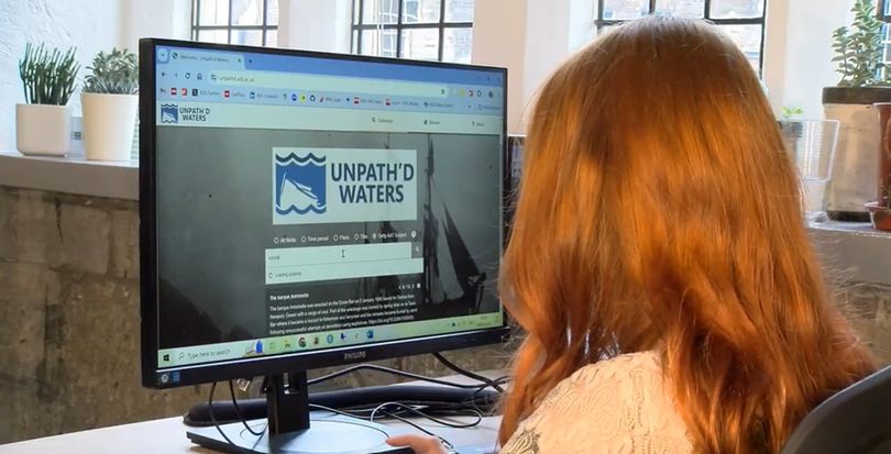 A photo taken behind someone using the Unpath'd Waters portal  