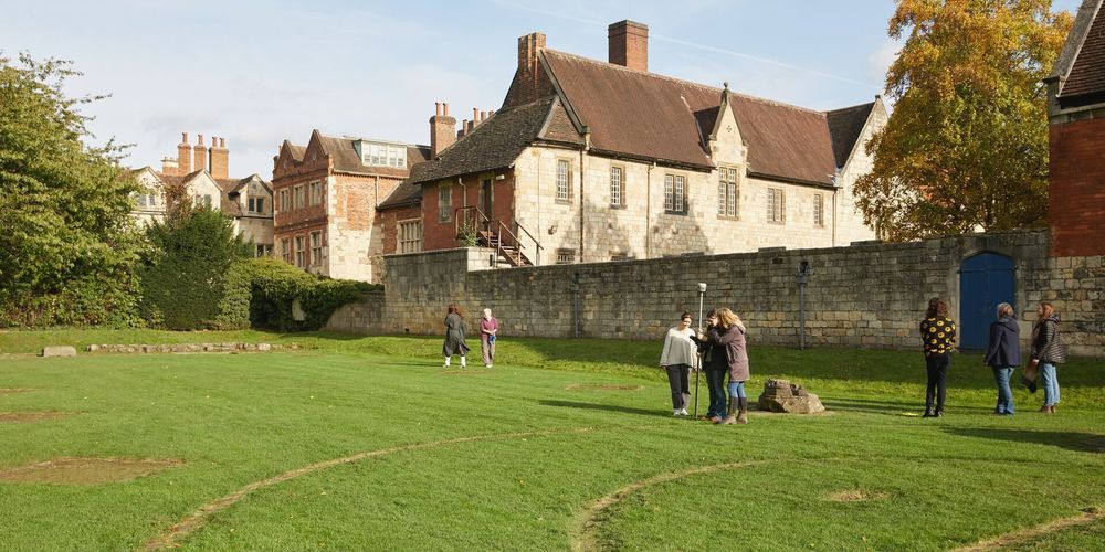 Group of undergraduate and postgraduate Archaeology students on a pretend field trip to St Mary's Abbey in the Museum Gardens, York.