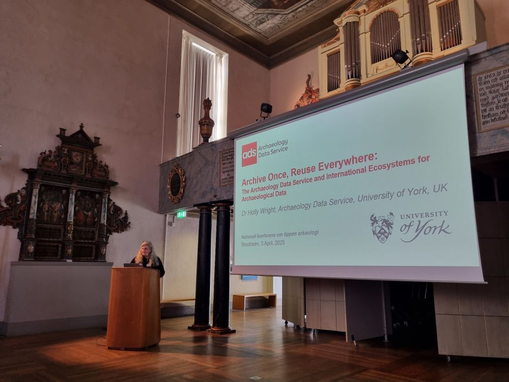 An image of Dr Holly Wright presenting on stage 