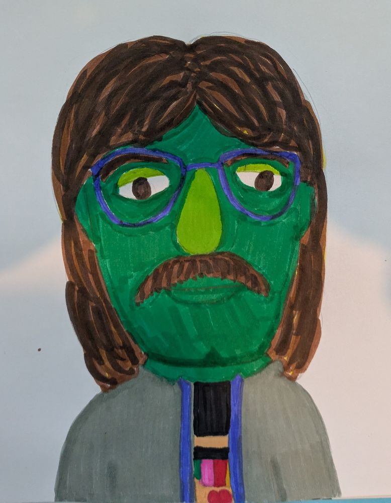 a marker drawn picture of John Green as a green muppet with his Silly Ray Cyrus wig on. He is wearing his blue glasses, a grey jacket, and a P4A 2024 T-shirt 