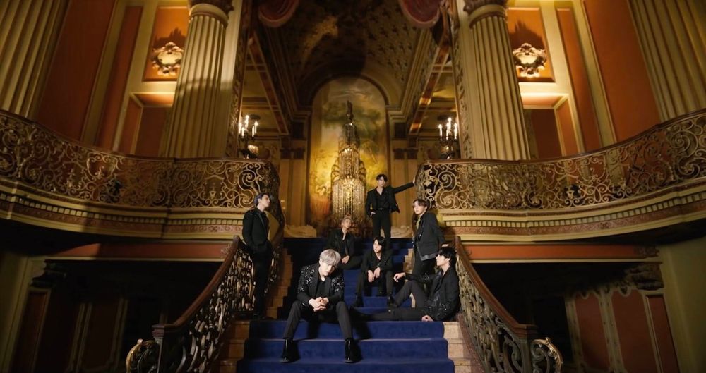 BTS sitting on the Black Swan Stairs
