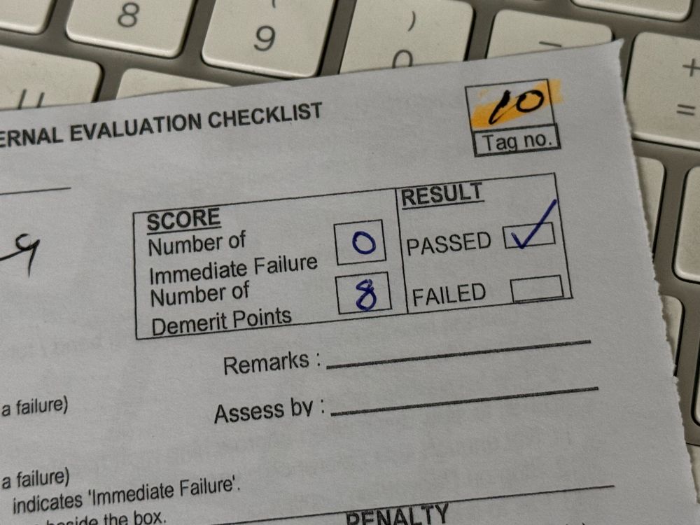 motorcycle test checklist with 8 demerit points and 0 immediate failures indicating a pass for the first of three assessments