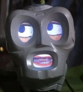 A robot head named 790 from Lexx. It has an idealized face shape in hard plastic, with eyes and mouth made of television screens.