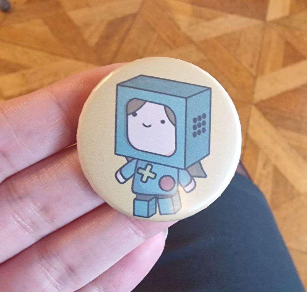 Button with a comic figure wearing a BMO cosplay costume