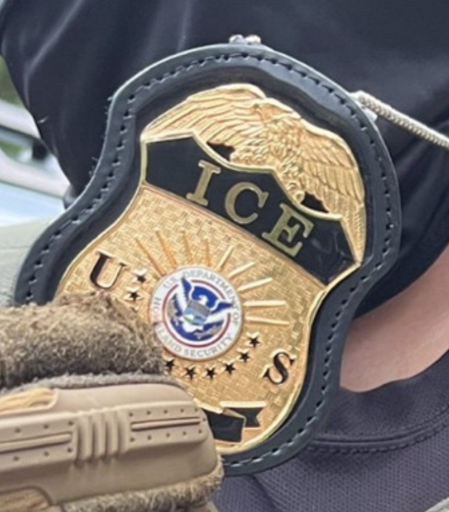 And unidentified officer flashing his badge, which says ICE and Department of Homeland Security