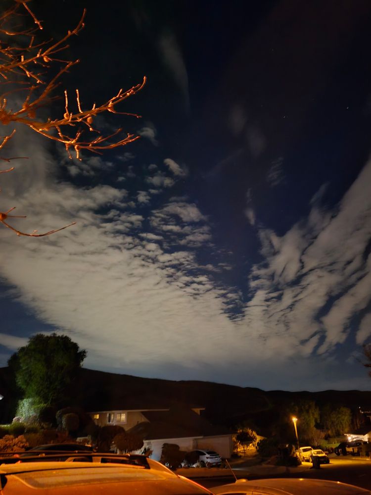 The clouds in the night sky in a different direction