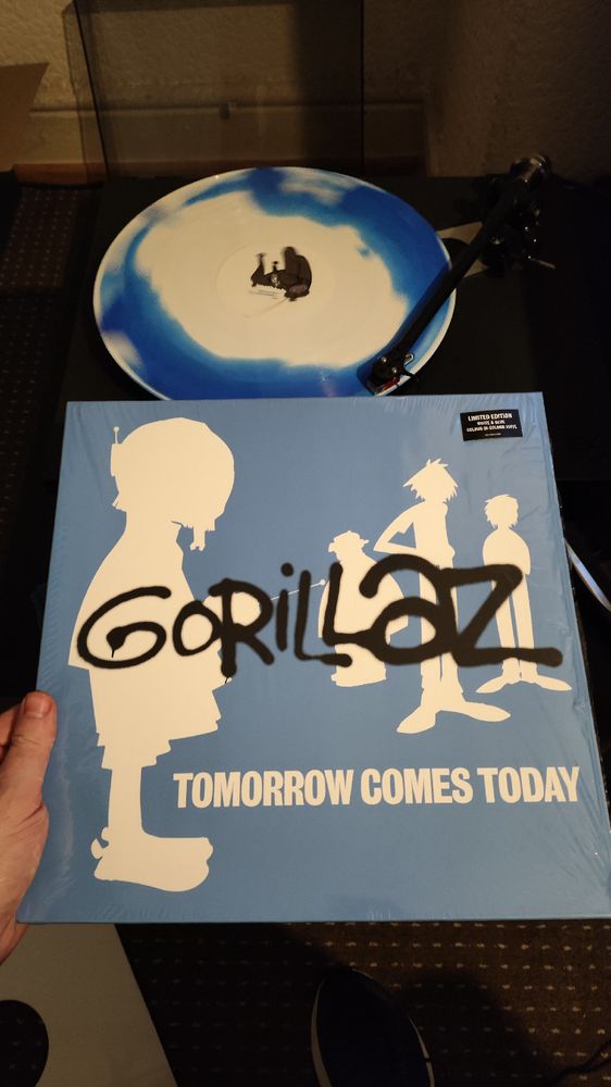 Cut out of the figures of Gorillaz in white on a blue background and a white and blue vinyl record 