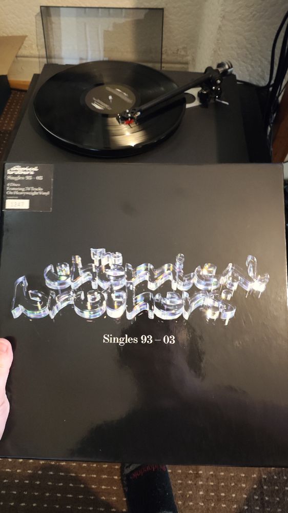 Black Boxset with The Chemical Brothers in a shiny blue font big on the front with Singles 93-03 below and a hype sticker top left 