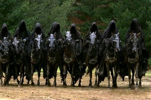 The nine Nazgûl from Peter Jackson’s Lord of the Rings film. Hooded in all black, they’re lined up side by side on armoured horses.