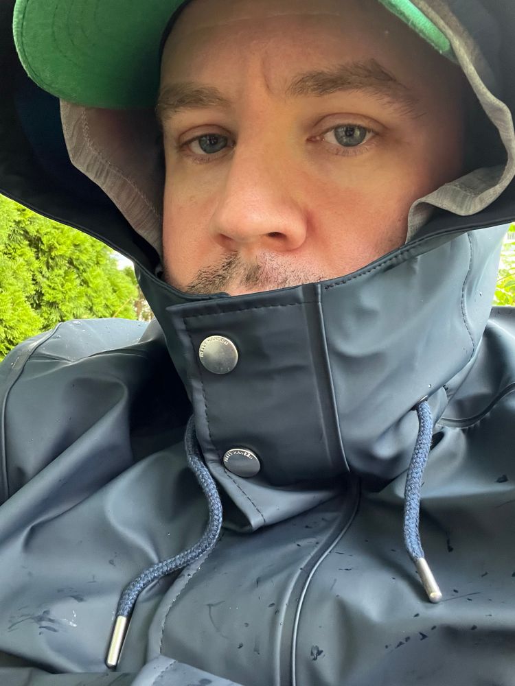 Me in a blue rain jacket looking miserable.