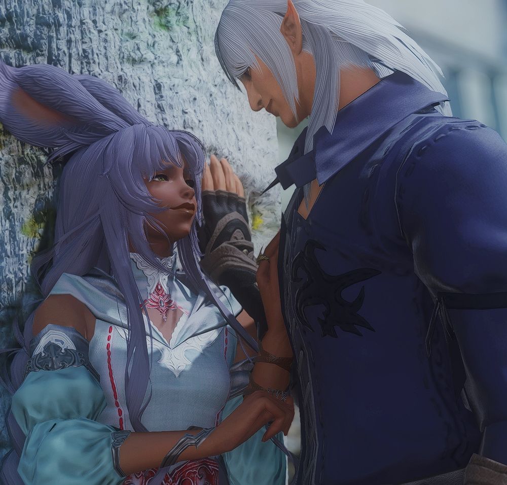 Hanan and Estinien are sharing a moment outdoors. Hanan has her back to a tree with white bark while Estinien has boxed her in with his hand resting against the tree behind her. They are looking longingly at one another.