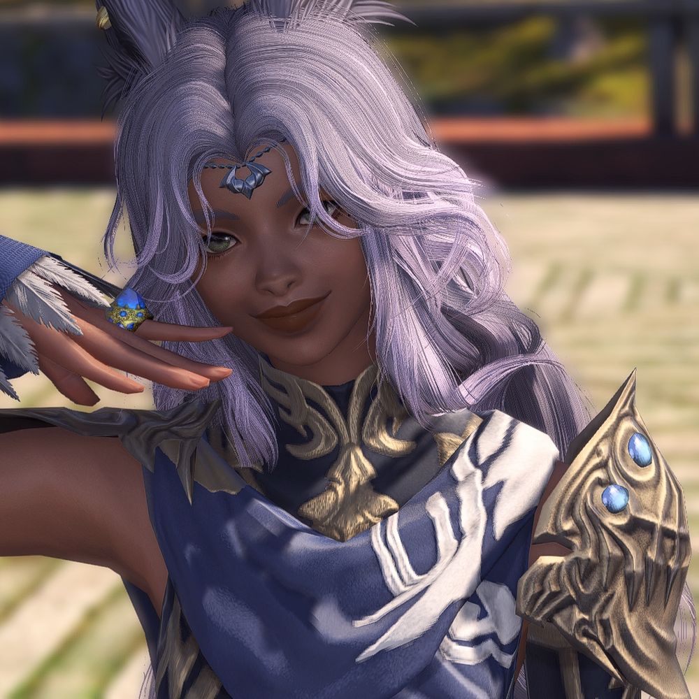 Hanan is smiling at the camera with her hand held up by her face. Her cheeks are narrower and her lips are fuller than her un-modded face.