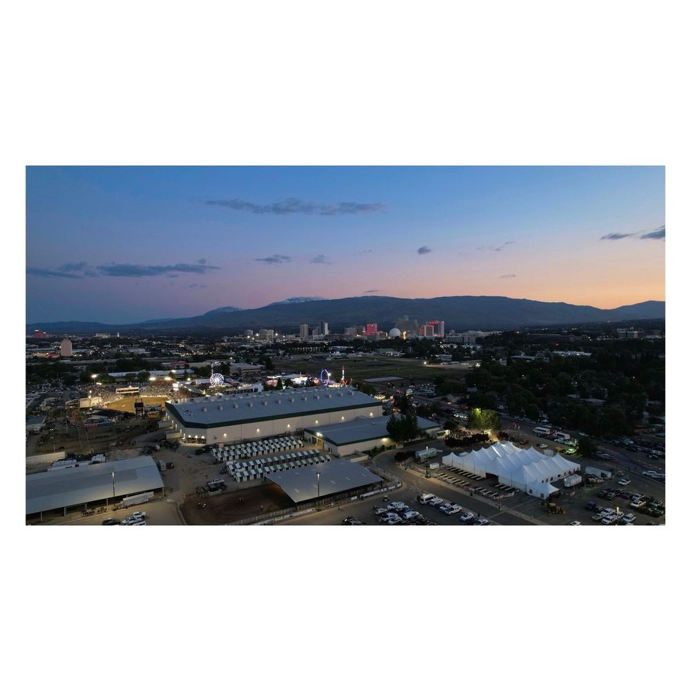 Aerial view of the Reno Rodeo at the Reno-Sparks Livestock Event Center with downtown Reno and the Sierra Nevadas in the distant background (June 24, 2023)