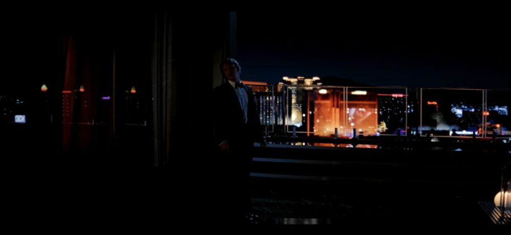 A man on a roof in a suit