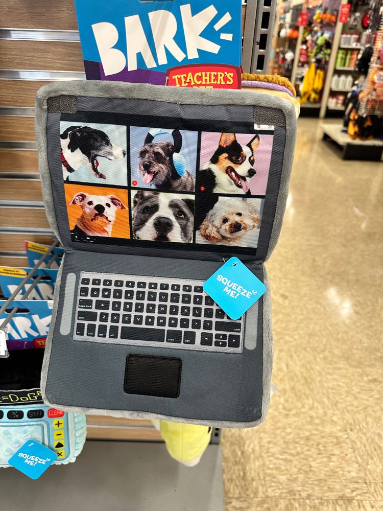 A dog toy that resembles a laptop with photos of others dogs as if on an all-dog zoom call