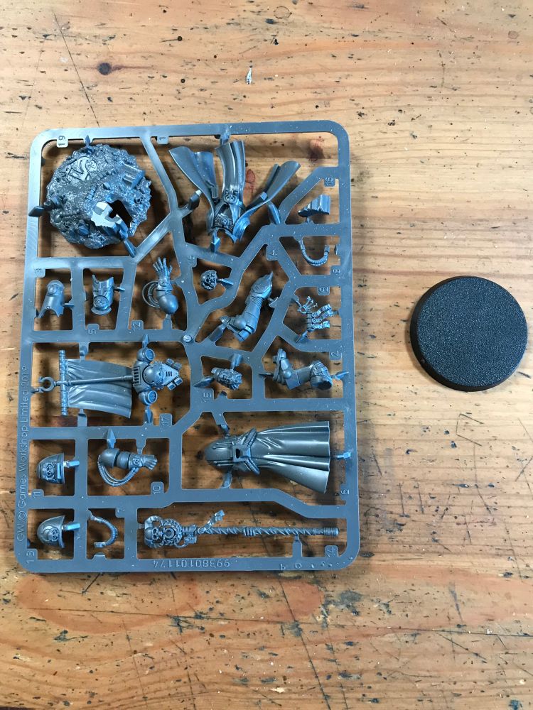 Sprue containing Chief Librarian Tigurius and a base
