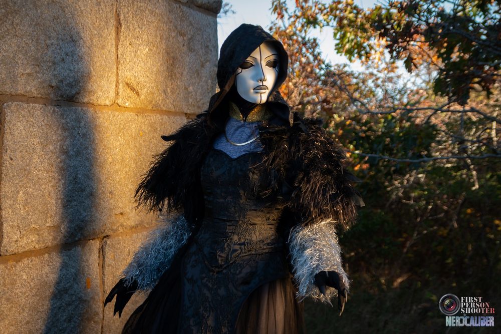 A cosplayer is dressed as Mother of Ravens from the animated Legend of Vox Machina. 