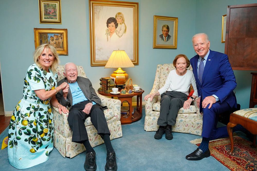 Jimmy and Rosalynn Carter next to Joe and Jill Biden. The perspective is all kinds of fucked up and it looks like the Carters are little dolls sitting next to the Bidens