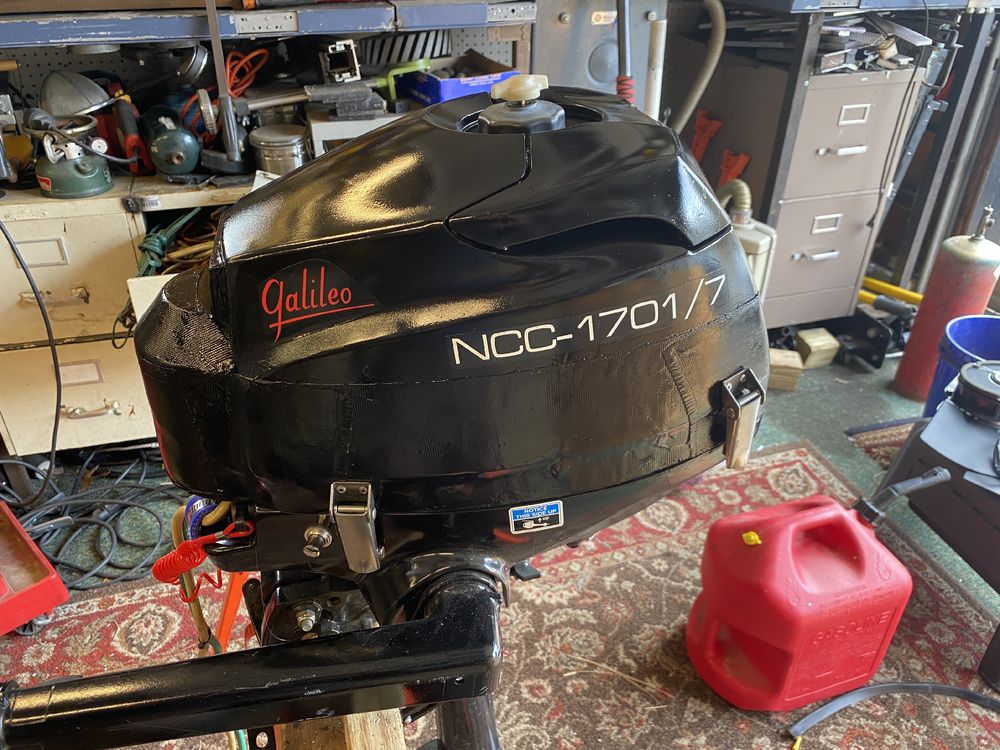 Small boat outboard motor with the markings NCC – 1701/7 and the name “Galileo” in stylized script.