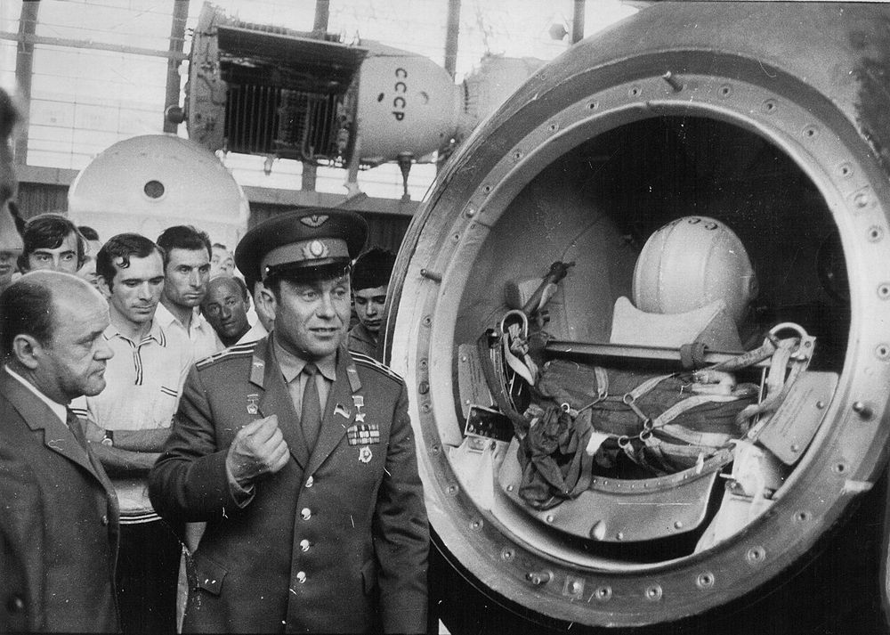 Pavel Popovich, wearing a military uniform, stands in a crowd of people in a building with spacecraft. Pic: Stevan Kragujević (courtesy of Tanje Kragujević), CC BY-SA 3.0 RS.