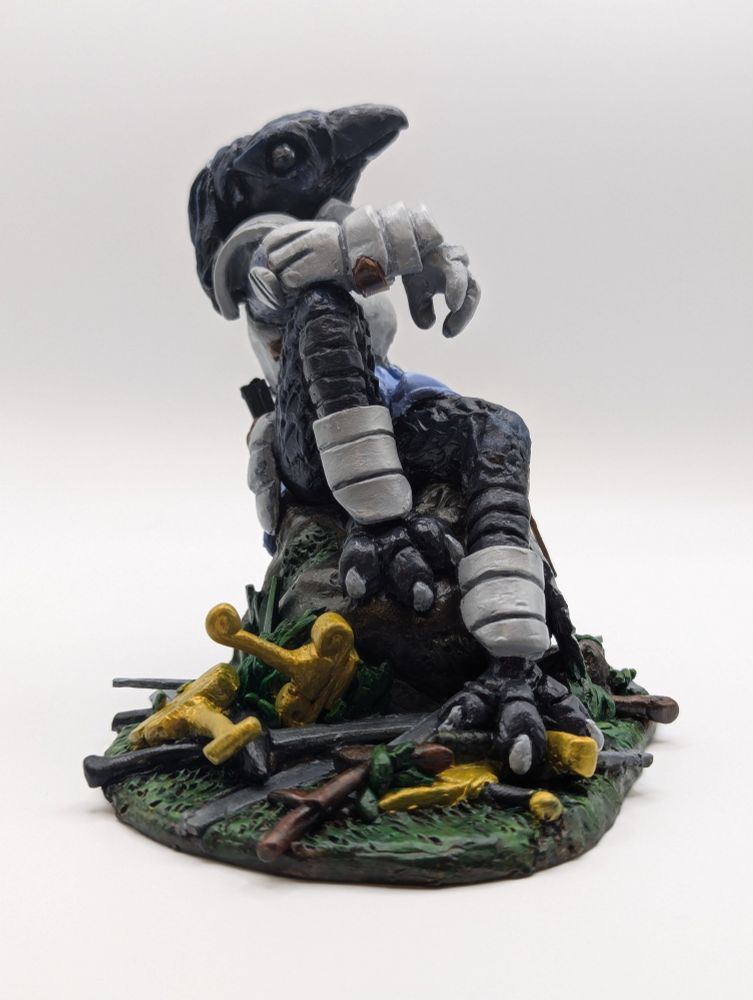 A polymer clay sculpture of an anthropomorphic crow in armour.