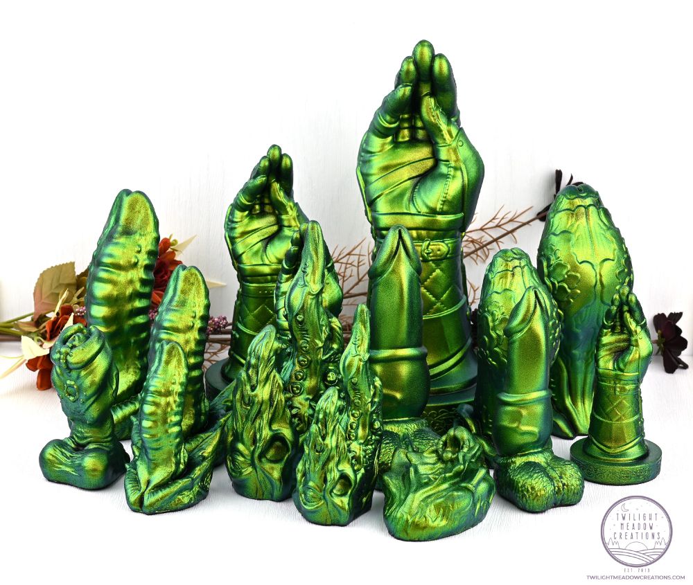 A group of fantasy sex toys in a metallic green coloration