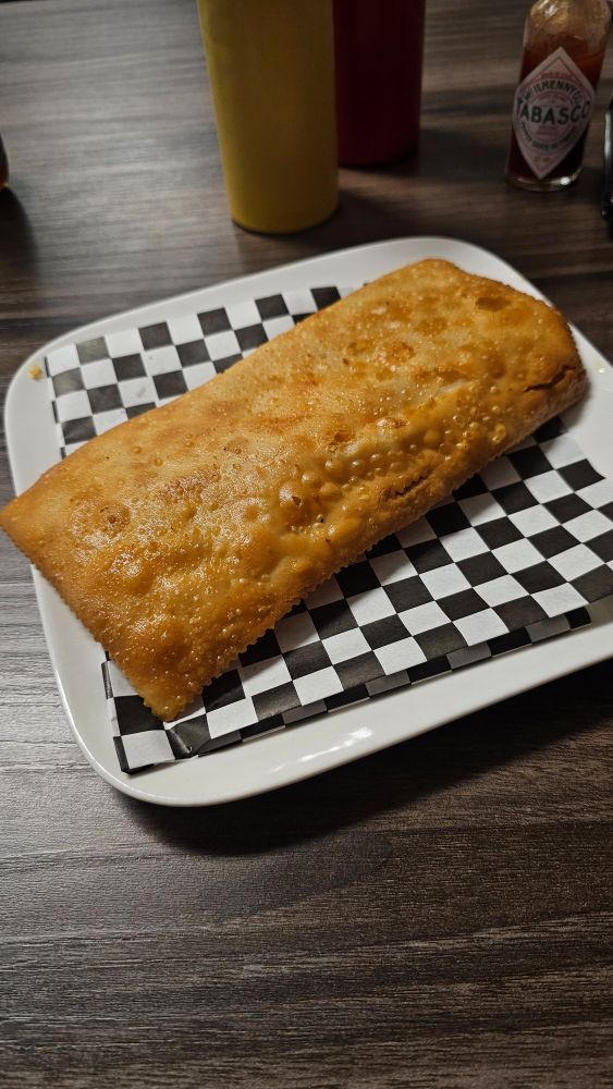 A pastel, a traditional Brazilian street food with ingredients placed inside dough and fried