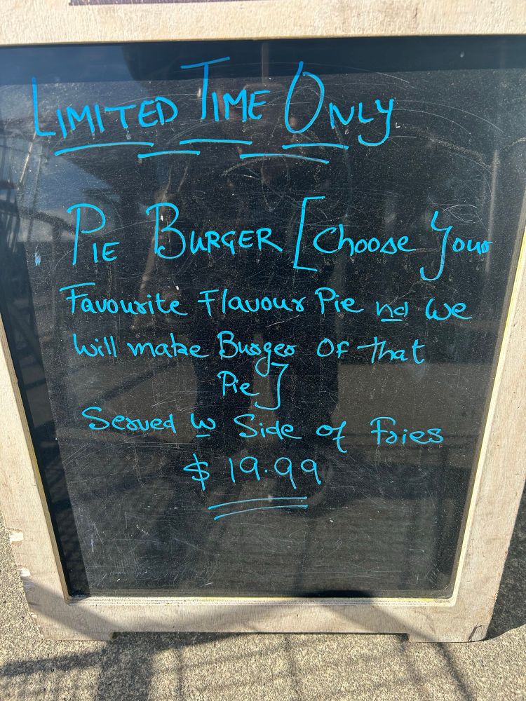 Sign outside a cafe in Wellington New Zealand during a burger festival, offering for a “Limited Time Only - PIE BURGER [choose your favourite flavour pie and we will make a burger of that pie]
