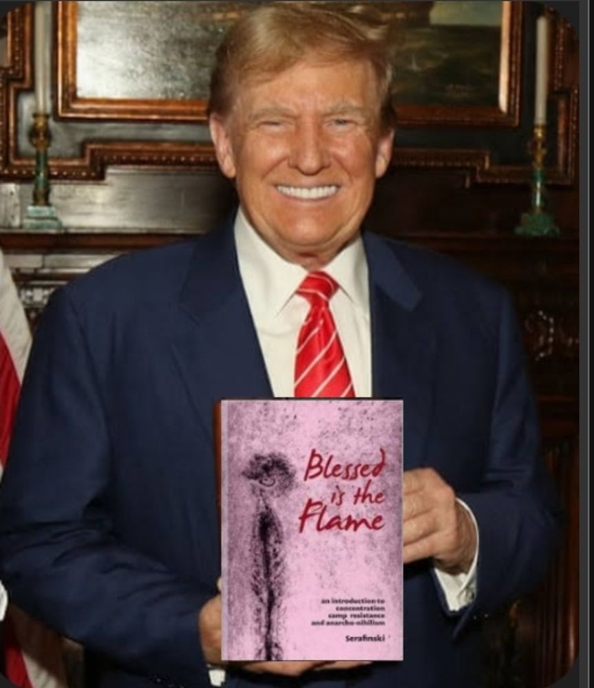 Trump proudly holding his copy of Blessed is the Flame