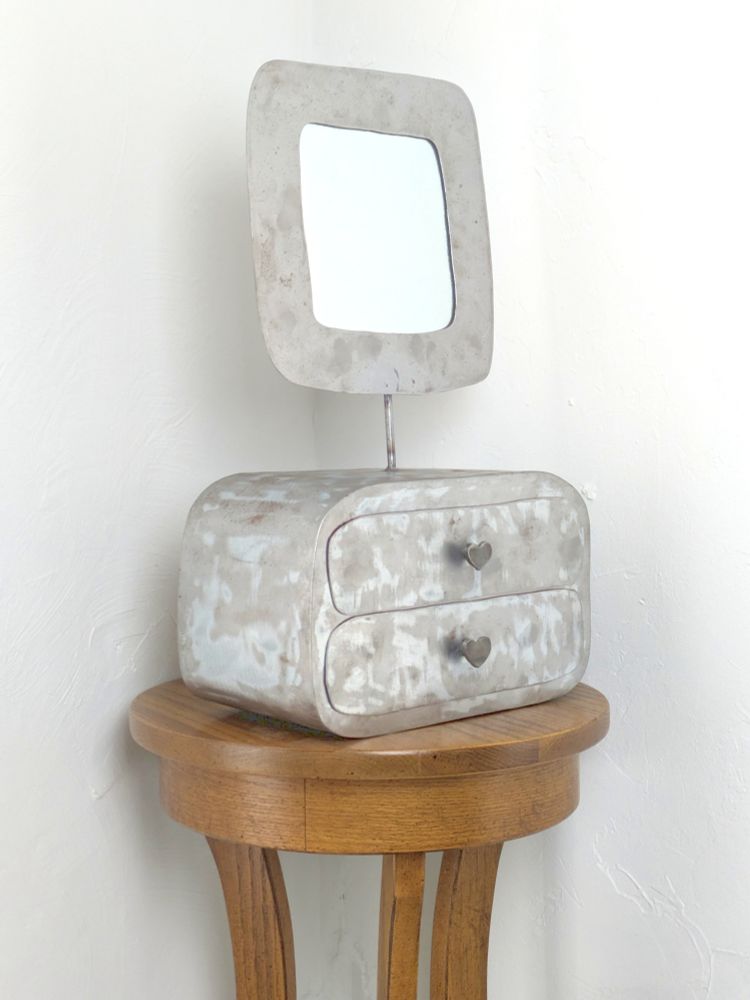 a handmade metal jewelry box with 2 drawers and a square mirror attached
