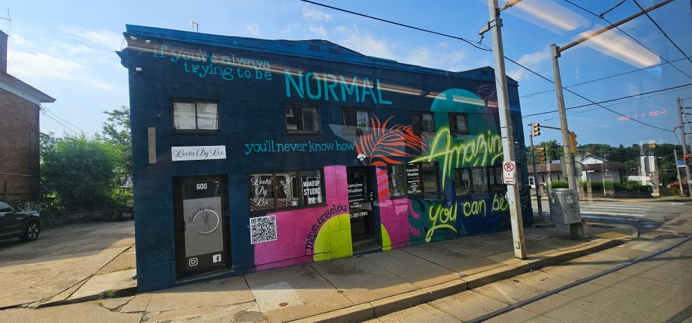 Vibrant mural with message: If you're always trying to be NORMAL, you'll never know how AMAZING you can be!