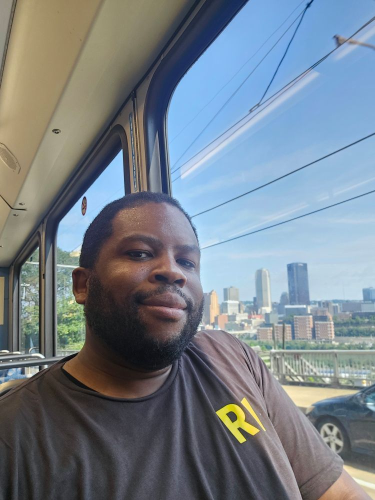 Selfie on T train with Pittsburgh City Skyline in the background