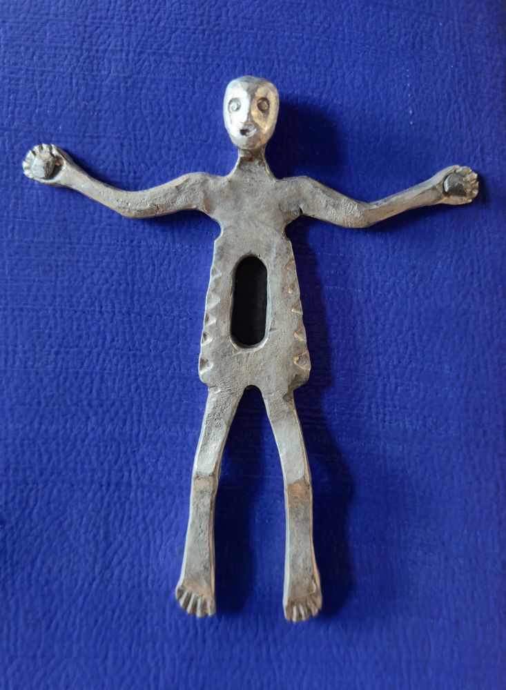 An iron figure, looking rather shocked that he has a keyhole through his torso.