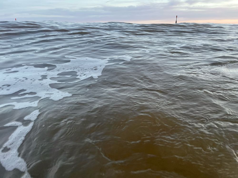Lumpy sea and distant beacon