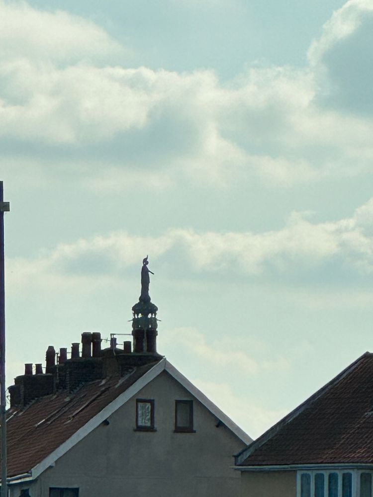 Britannia, rising up out of a chimney. 