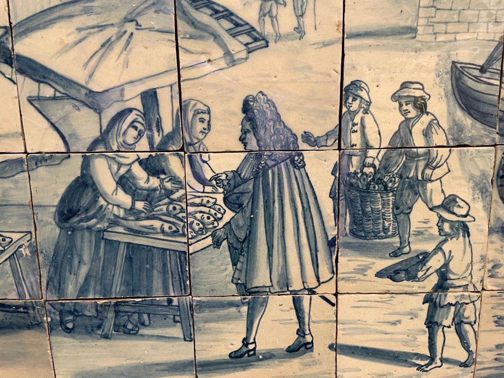 Close-up of 18th century porcelain in the Museu de Lisboa depicting a fish market on the banks of Lisbon.