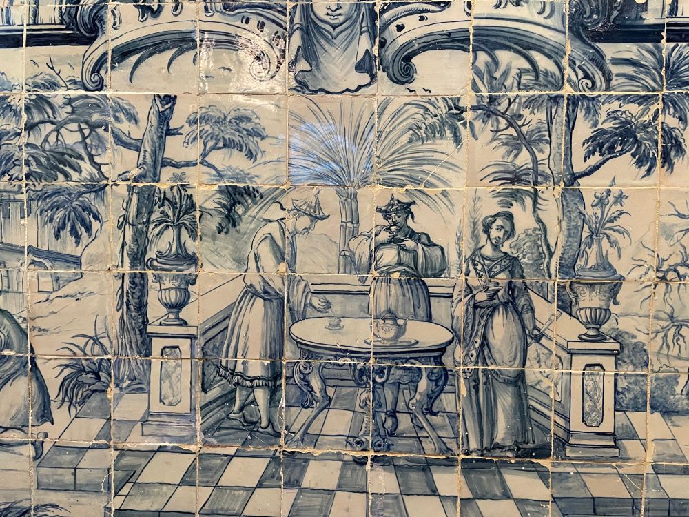Close-up of 18th century porcelain in the Museu de Lisboa depicting Chinese men drinking tea.