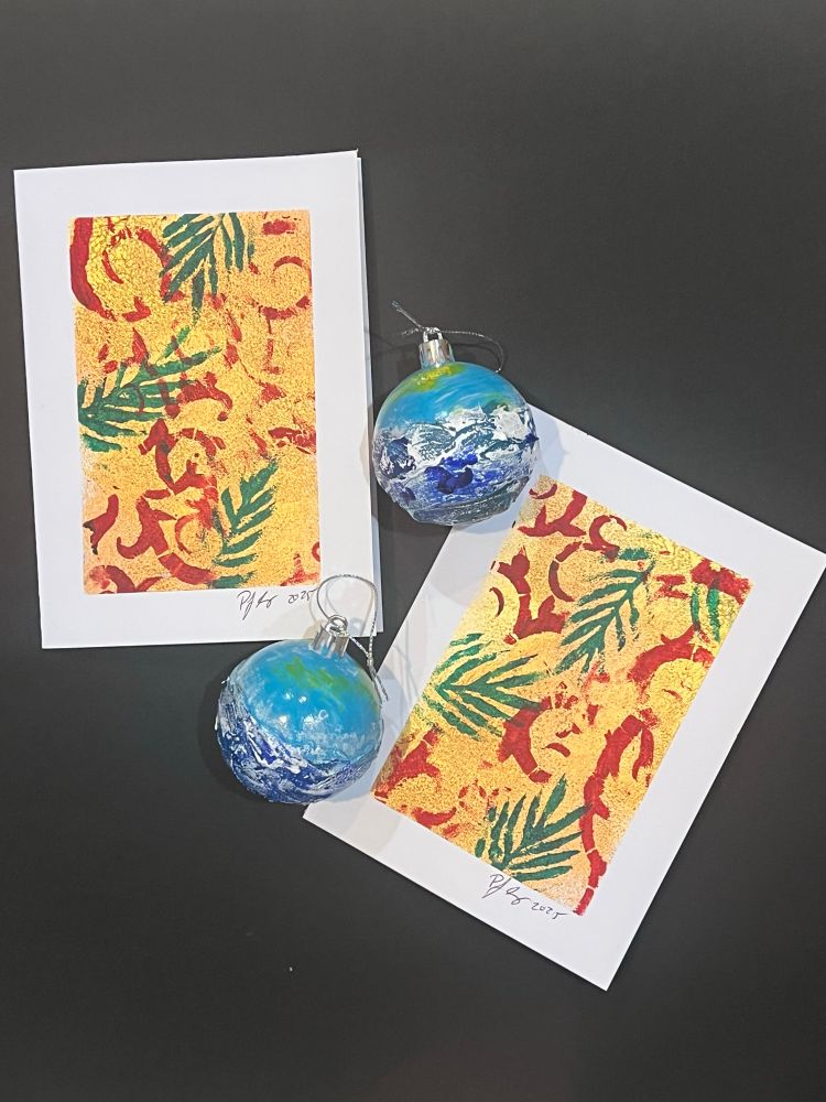 Two abstract Christmas cards and two ornaments either waves on them. 