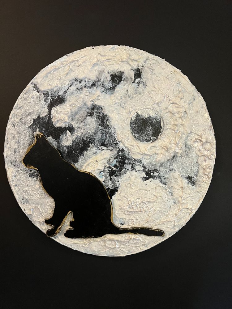 Moon painting with a sitting cat silhouette on it. 