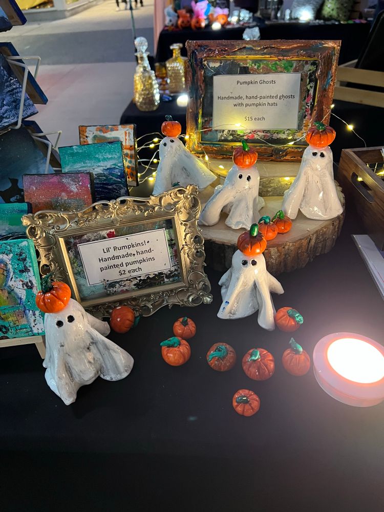 A table of Halloween items at a flea market. 