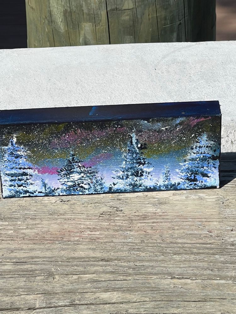 A small painting of a winter scene. 