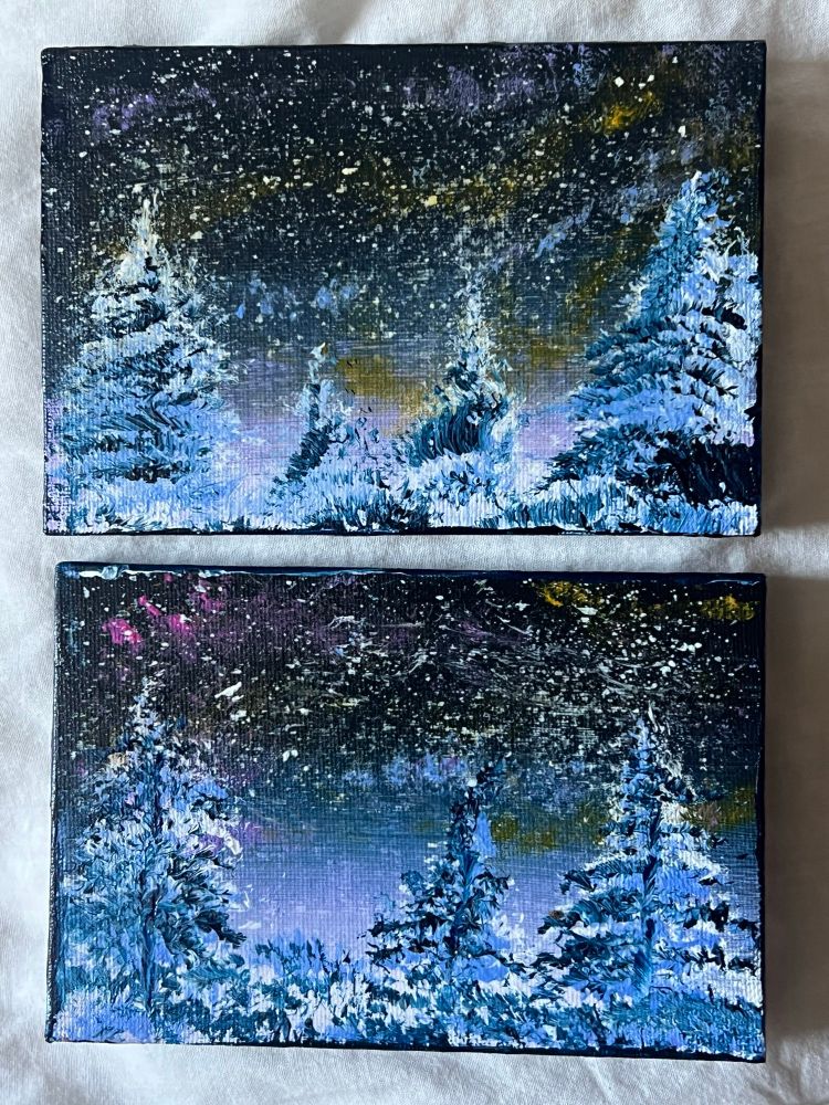 Two small canvas paintings of a winter woods scene with a northern lights night sky. 