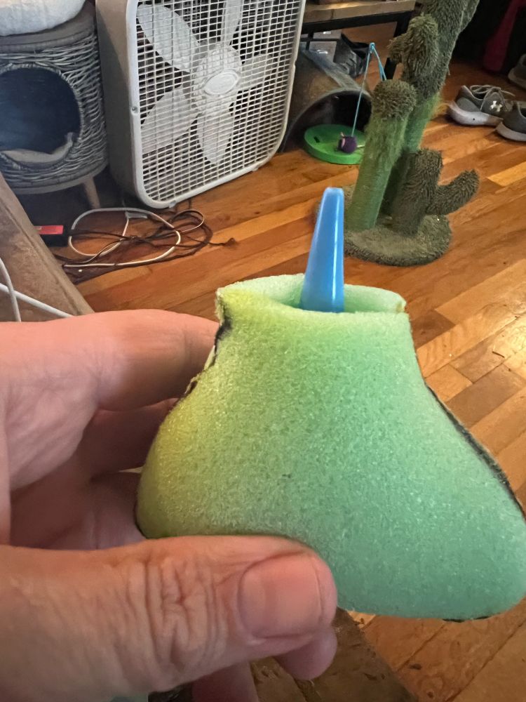Foam in the shape of a bird with an ear syringe bulb inside.